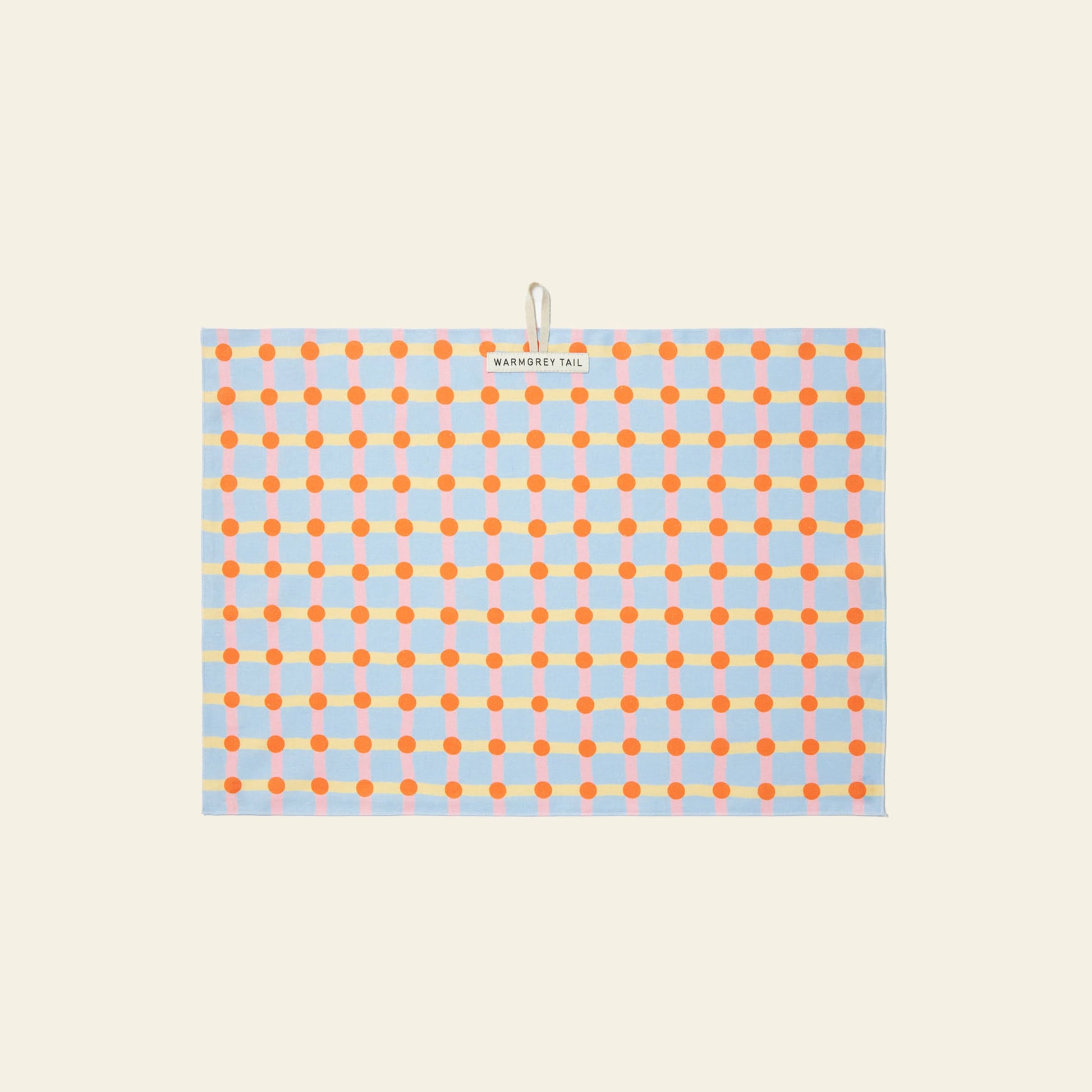 The WARMGREY TAIL Dot Check Kitchen Cloth 2 is a rectangular tea towel with orange and red dots connected by blue lines on a light background, featuring a handy top-center loop and label for easy hanging.