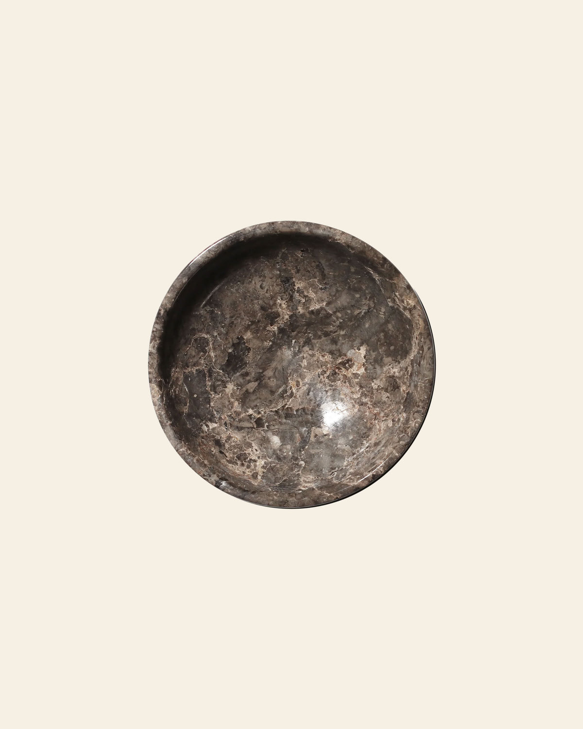 Top-down view of a stillgoods Luna Dish, a moon-inspired, dark grey stone trinket dish featuring white veining.