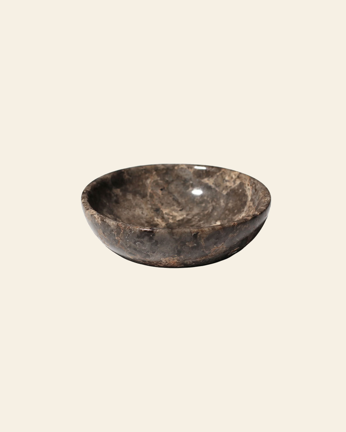 The stillgoods Luna Dish is a shallow, moon-inspired trinket dish with a dark, mottled brown and gray surface and a rounded base.